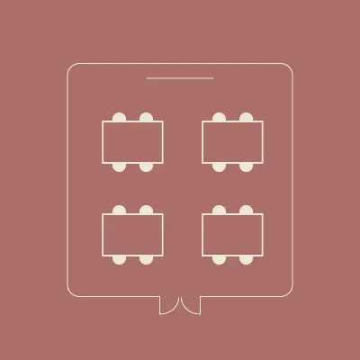 Pictogramme d'une disposition de salle en îlots, quatre tables de travail groupées